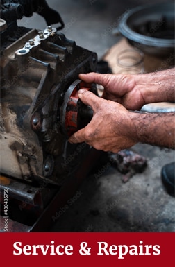 man repairing wheel on tractor