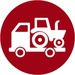 red round icon with a truck hauling a tractor facing leftward