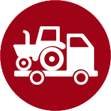 red round icon with a truck hauling a tractor facing rightward